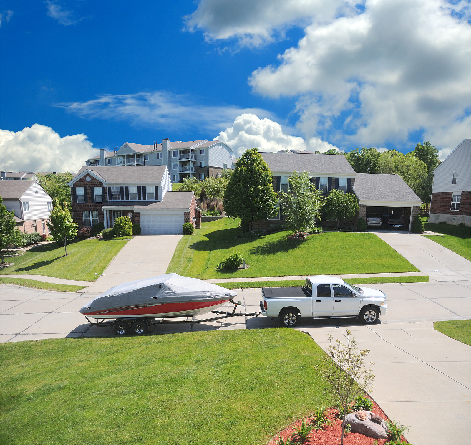 trailer repairs or servicing - a street in the suburbs with a boat and trailer