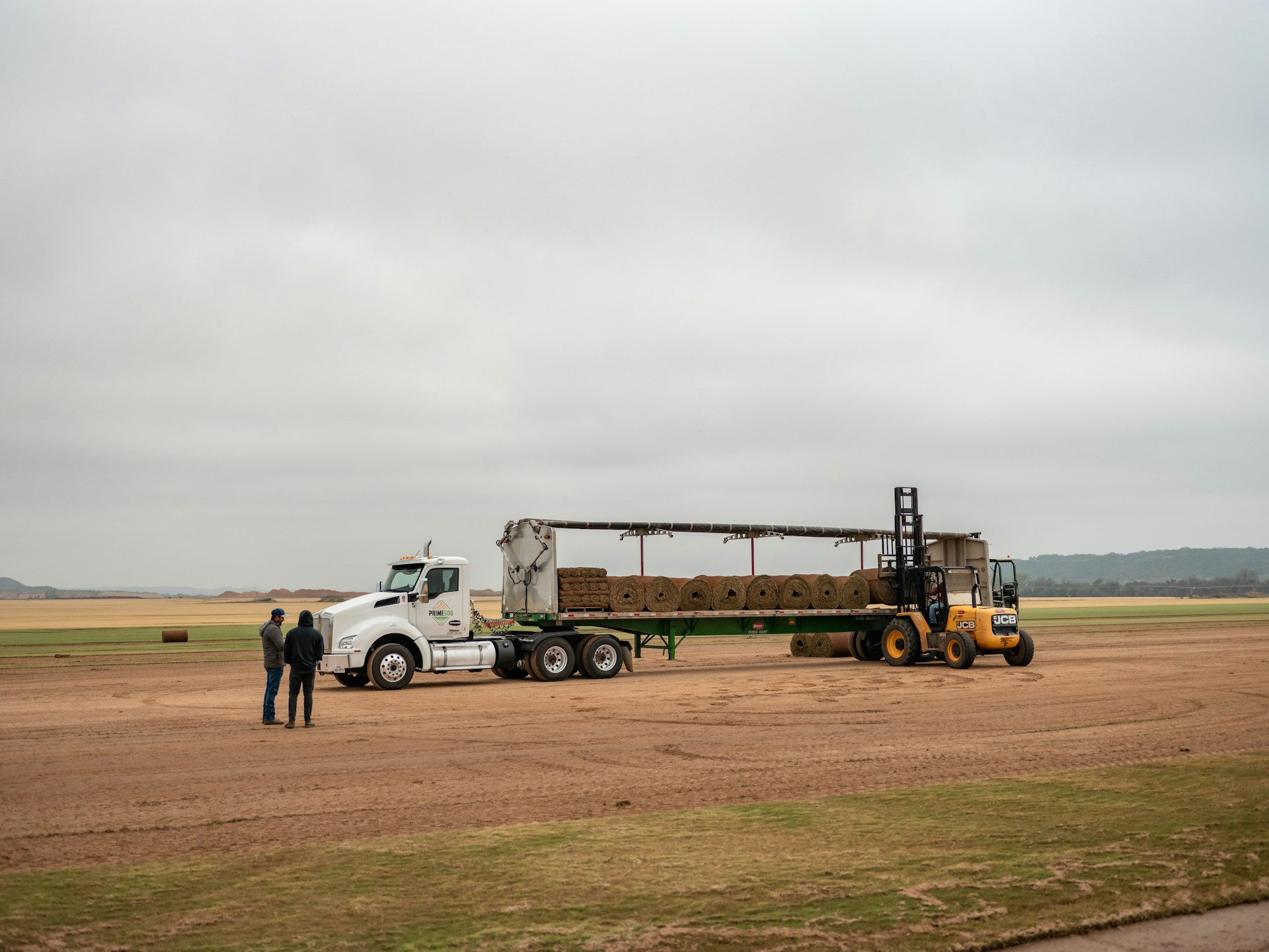 construction trailers - Loading-Hay-Bales-Onto-A-Semi-Trailer
